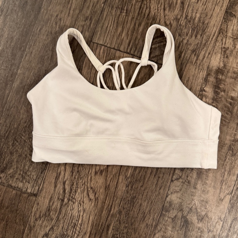 Women's white Sports Bra w crisscross back. Pads inside.